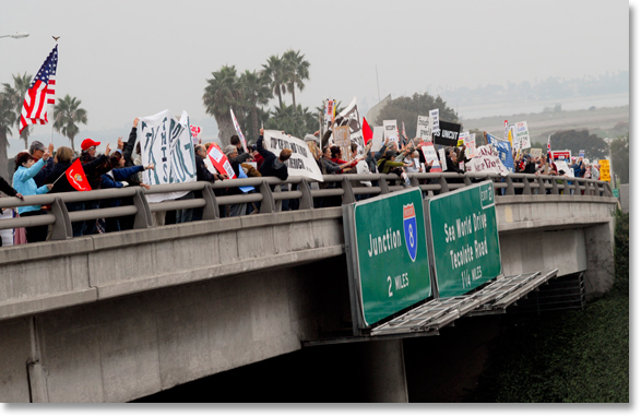 Occupy San Diego on the afternoon of November 17 filled the Clairemont Drive Bridge to prepare for a banner drop and to protest the need for rebuilding of aging infrastructures on National Day of Action. All photos and captions by Johnny Nguyen.