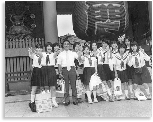 “Teacher and Students”.  High school students and teacher from Hiroshima, Japan standing at the entrance of Sensoji Temple in Asakusa, Tokyo.  August 2001.