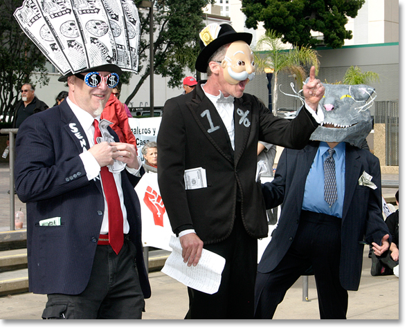 May Day 2012, San Diego, California. -- Occupy particpatory theater demonstrates the role of the 1%, Senator Cash and a Fat Cat in Freedom Plaza. Photo by Nic Paget-Clarke.