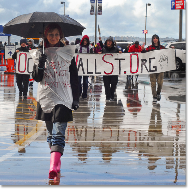 On December 12, Women Occupy organizes a rally at USS Midway and proceed to demonstrate on North Harbor Drive (San Diego) despite the rain. All photos and captions by Johnny Nguyen.