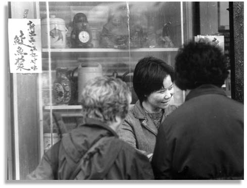 "Selling Her Wares", Oakland Chinatown - 2000. Photo by Bruce Akizuki.