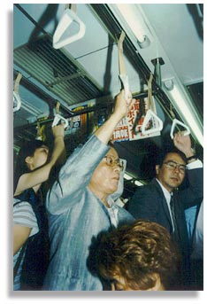 “Commuter”. On the Ginza Line in Tokyo, Japan. August 2000