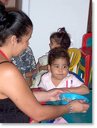 Lunchtime in a home for children sponsored by the city government of Tocuyito in the state of Carabobo