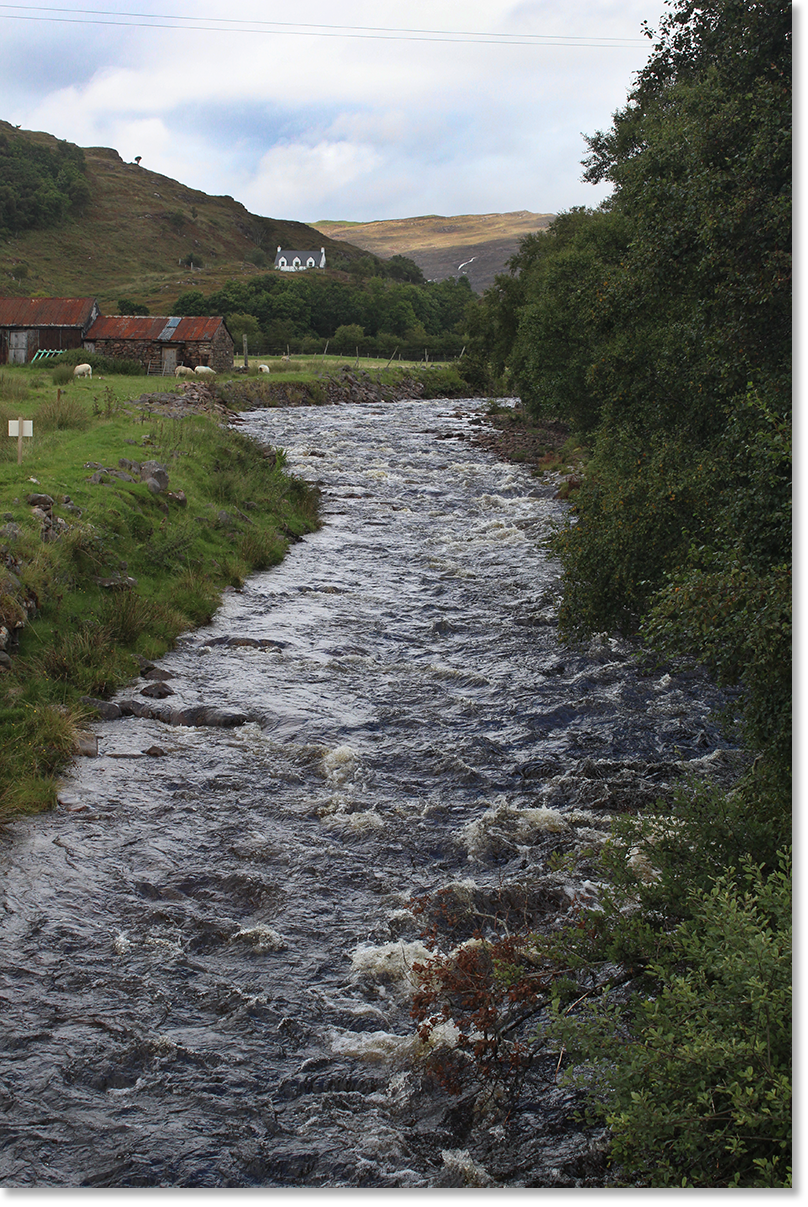 A river rushes towards the sea, the Inner Sound, between the Applecross peninsula and the Inner Hebrides islands.