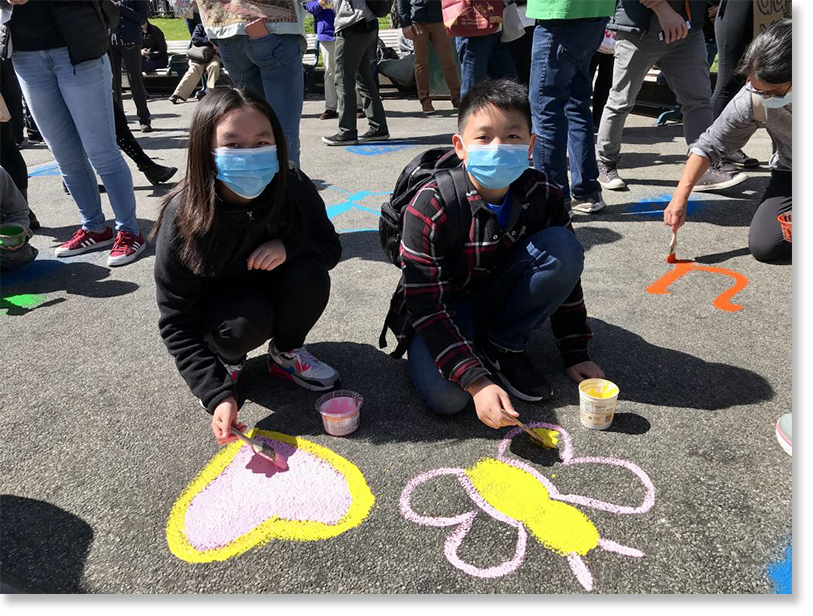 Painting butterflies, a symbol of resilience, at Portsmouth Square, San Francisco Chinatown, March 20, 2021. Photo by Eddie Wong.