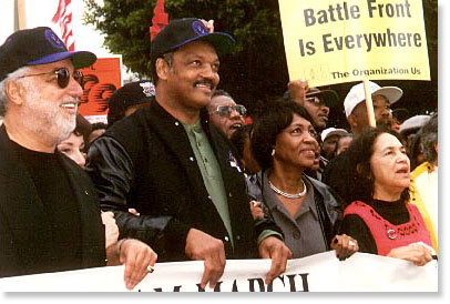 Danny Bakewell, Rev. Jesse Jackson, Congresswoman Maxine Waters, and UFW VP Dolores Huerta march in Los Angeles at the February, 1998 "Save The Dream" march. Photo by Butch Wing.