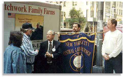Missouri farmers Roger and Mark Allison and Rhonda Perry, bringing 6,000 pounds of Patchwork Family Farms ham to New York, are greeted by members of the New York Central Labor Council. Photo by Lindsay Howerton.