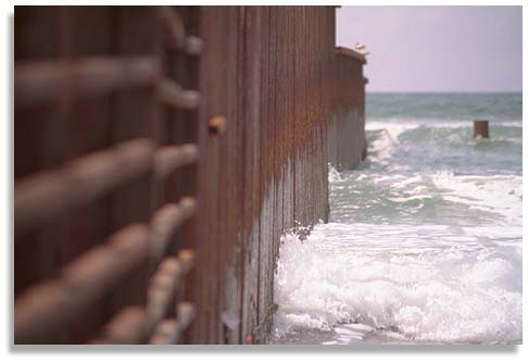 iron wall continues into the Pacific Ocean as part of the U.S. / Mexico border. Photo by Nic Paget-Clarke.